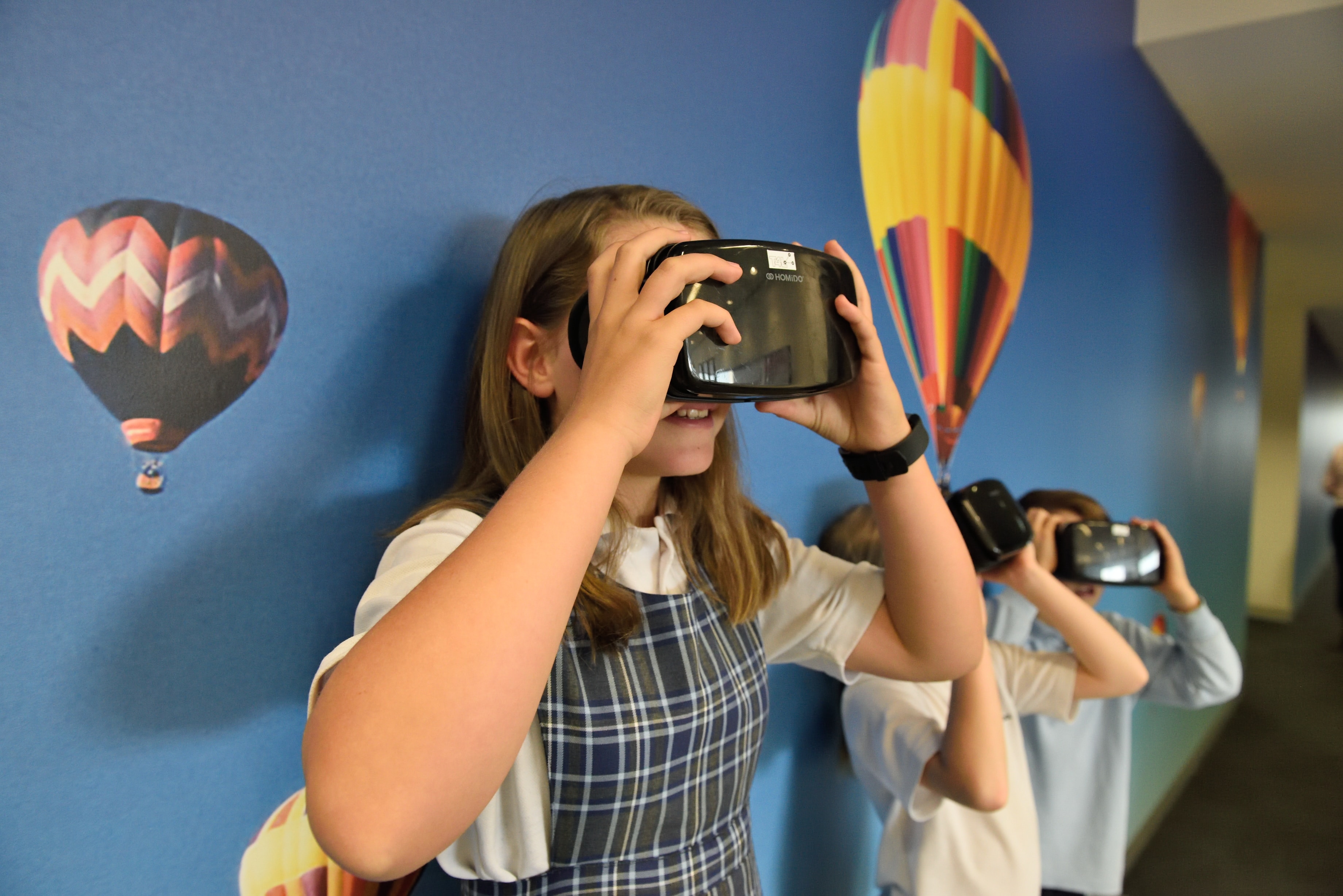 girl playing with virtual reality headset